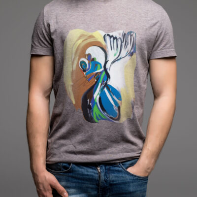 A man in a grey t-shirt and denims holds his hands in pockets. Isolated on grey