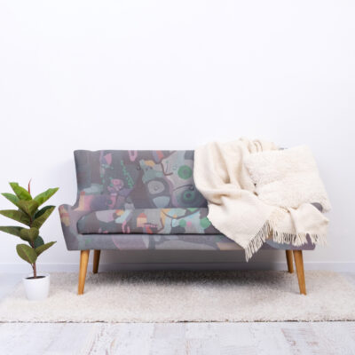 Light room interior with gray coach and green plant in pot