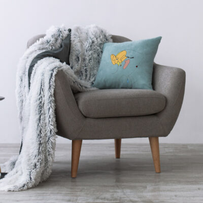 Minimalist home workspace design. Modern armchair with blue pillow and soft plaid, next to small table with laptop in scandinavian interior with light wall, empty space for ad, flat lay, panorama